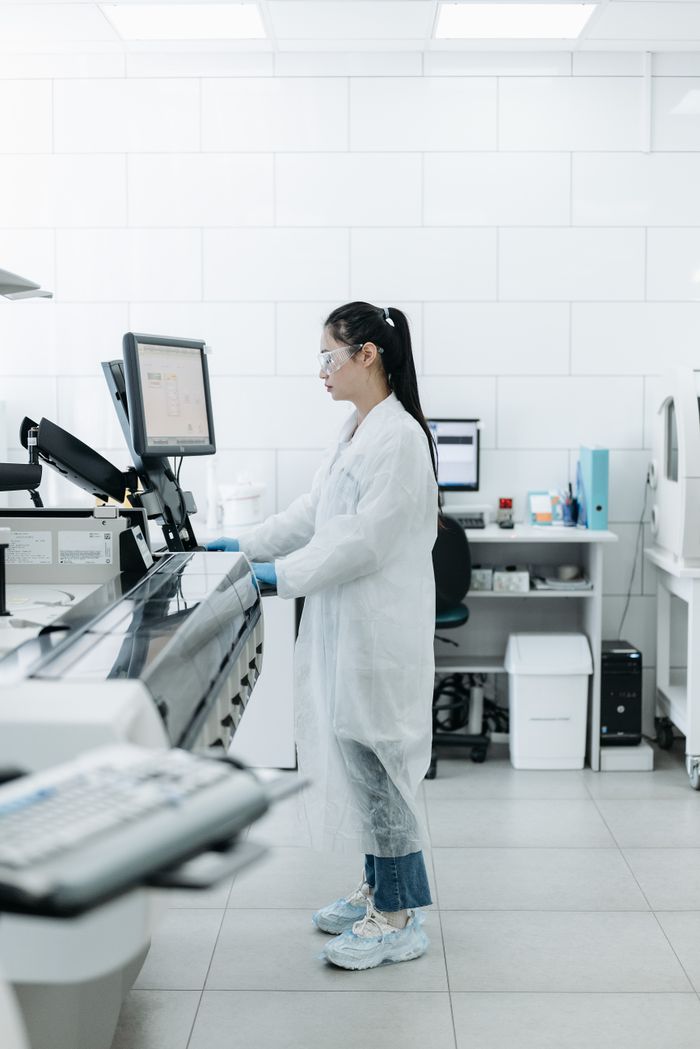 About Lab scientist conducting research in a high-tech laboratory environment.